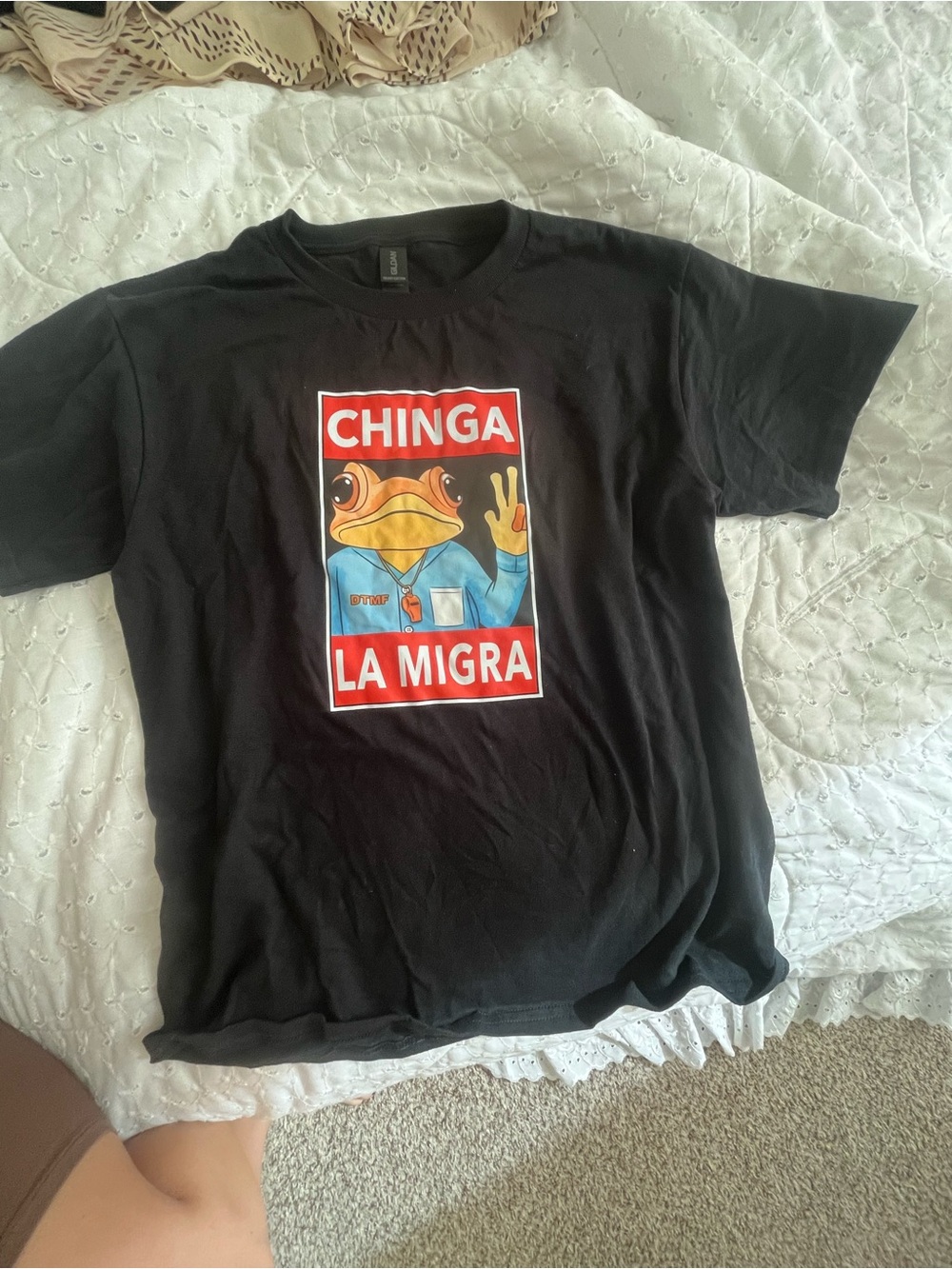 Black Tee with  Sapo Concho holding anti-ICE message.